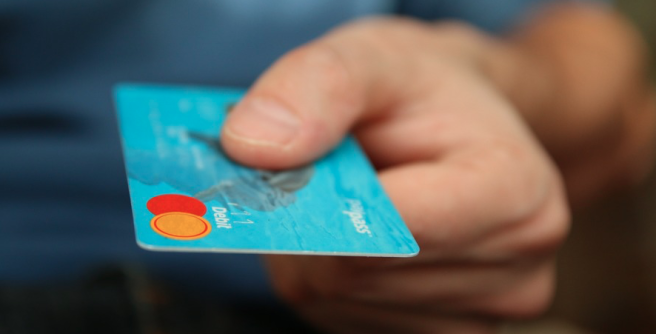 hand with credit card in context of product instruction translation for foreign markets