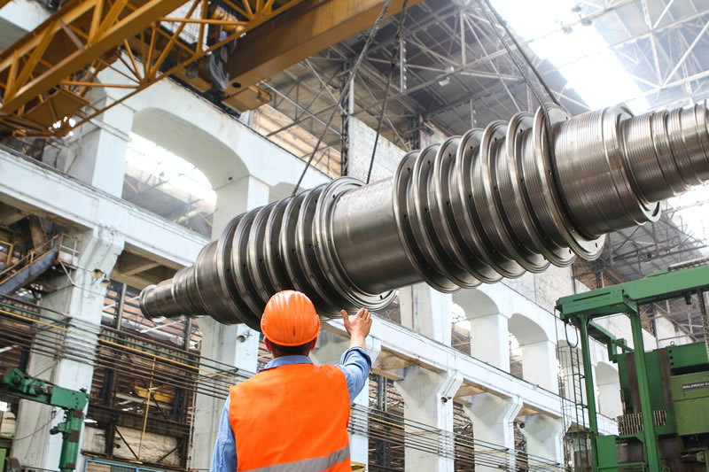 Image of shaft being moved on factory floor to illustrate the impact of translation services on the manufacturing supply chain