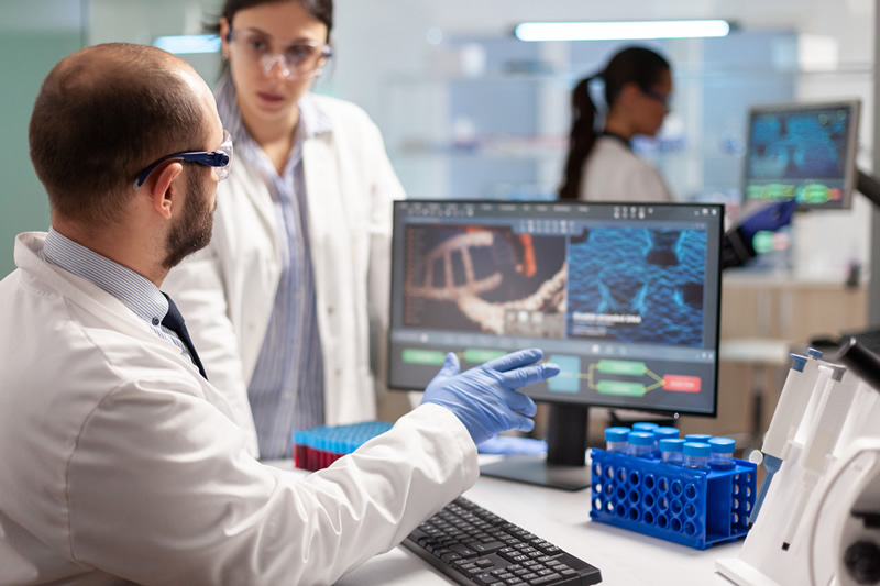 Two scientists in the lab dealing with translations of scientific jargon.